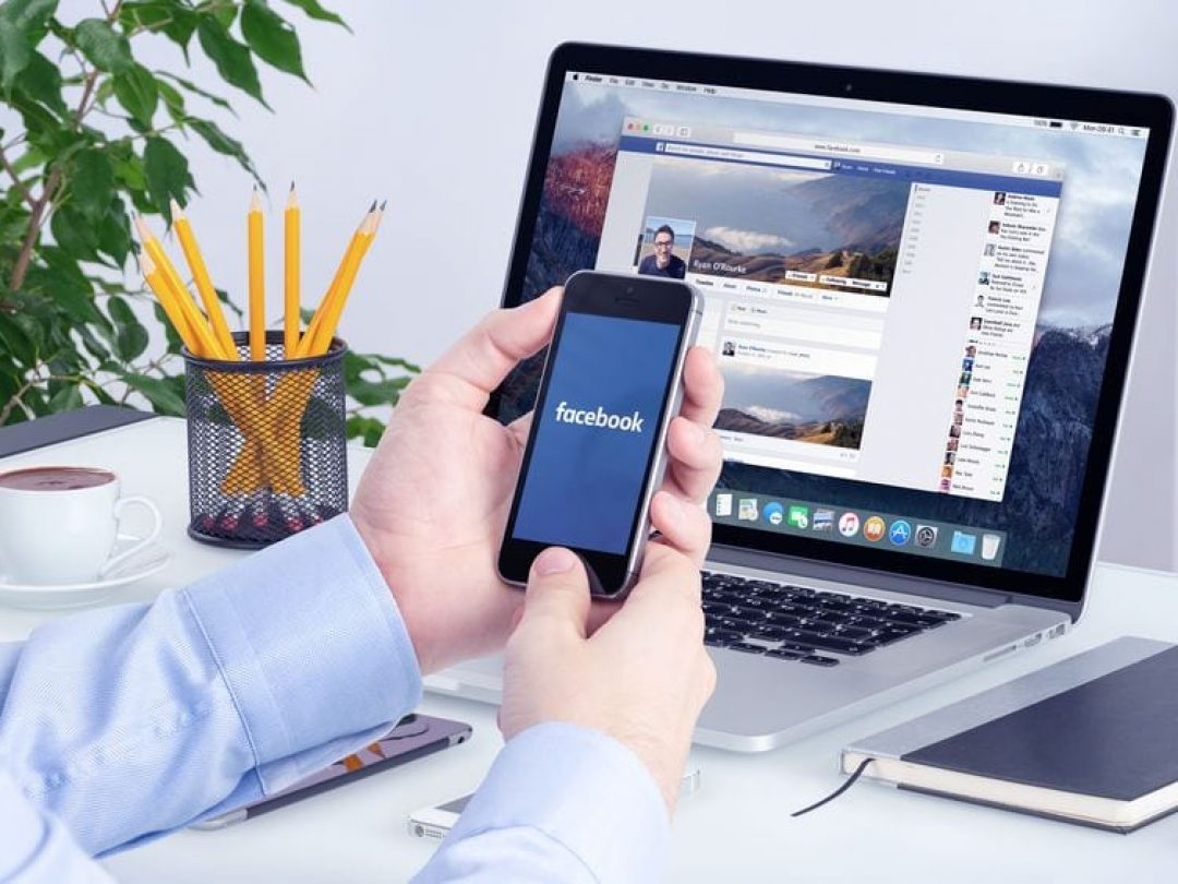 Facebook app on the Apple iPhone display and desktop version of